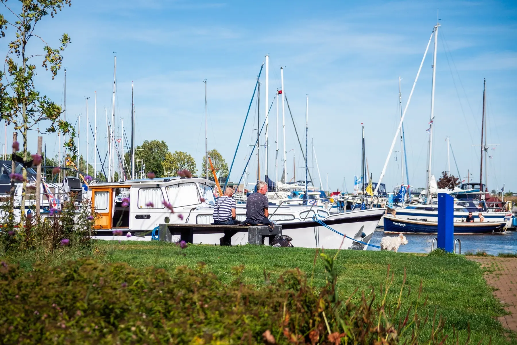 Twee mensen op een bankje bij Jachthaven de Rakken